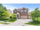 Two-story brick home with a well-manicured lawn and attached two-car garage under a blue sky at 1821 Midnight Pass, Brownsburg, IN 46112