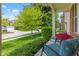 Inviting front porch with comfortable seating and vibrant flowers, set against a lush green lawn at 1821 Midnight Pass, Brownsburg, IN 46112