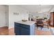 Open kitchen featuring a blue island, stainless steel appliances, and seamless flow to the breakfast nook at 1821 Midnight Pass, Brownsburg, IN 46112