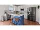 Modern kitchen featuring stainless steel appliances, blue island, and white cabinetry at 1821 Midnight Pass, Brownsburg, IN 46112