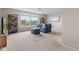 Bright living room with large windows, neutral carpet, and cozy blue seating at 1821 Midnight Pass, Brownsburg, IN 46112