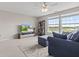 Cozy living room with large windows, comfortable blue furniture, and a view of the outdoors at 1821 Midnight Pass, Brownsburg, IN 46112