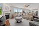 Cozy living room with a fireplace, comfortable seating, and ample natural light from the large windows at 1821 Midnight Pass, Brownsburg, IN 46112