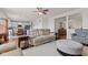 Bright living room showcasing an open-concept design with wood floors, neutral decor and seamless flow to kitchen at 1821 Midnight Pass, Brownsburg, IN 46112