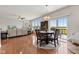 Open-concept living and dining area with wood floors, fireplace, and sliding doors to the deck, perfect for entertaining at 1821 Midnight Pass, Brownsburg, IN 46112