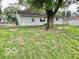 Spacious backyard featuring mature trees, a cozy fire pit, and swing at 1834 Chandler Ln, Columbus, IN 47203