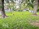 Sprawling backyard featuring mature trees, lush lawn, and natural scenery at 1834 Chandler Ln, Columbus, IN 47203