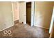 Carpeted bedroom featuring closet for storage at 1834 Chandler Ln, Columbus, IN 47203