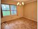 Dining room featuring a window overlooking the front yard and a chandelier at 1834 Chandler Ln, Columbus, IN 47203