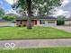 Charming single-story home featuring a well-manicured lawn and attached garage at 1834 Chandler Ln, Columbus, IN 47203