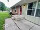 Exterior view of the front of a home, featuring a large front window, a red door, and concrete steps at 1834 Chandler Ln, Columbus, IN 47203