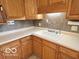 Traditional kitchen featuring wood cabinetry, laminate countertops, and a drop-in sink at 1834 Chandler Ln, Columbus, IN 47203