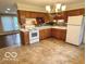 Kitchen area with wood cabinets and vinyl flooring at 1834 Chandler Ln, Columbus, IN 47203