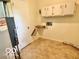 Laundry area with storage cabinets, hookups, and a utility sink at 1834 Chandler Ln, Columbus, IN 47203