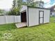 View of a new shed in the backyard with a roll up door and side door at 1834 Chandler Ln, Columbus, IN 47203