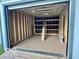 Interior view of a new shed featuring wood beam construction, plywood floor and storage shelves at 1834 Chandler Ln, Columbus, IN 47203