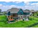 Stunning back exterior featuring a screened in porch, deck, and outdoor hot tub at 18398 Cross Lakes Ct, Westfield, IN 46074