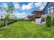 Expansive backyard with lush green grass, covered hot tub, and screened-in porch at 18398 Cross Lakes Ct, Westfield, IN 46074