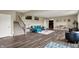 Open finished basement with luxury vinyl flooring, wet bar, and comfortable seating area at 18398 Cross Lakes Ct, Westfield, IN 46074
