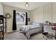 Bright bedroom features stylish decor, modern lighting, and a view of the outdoors at 18398 Cross Lakes Ct, Westfield, IN 46074