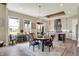 Dining area with rustic table, modern light fixture, and views of the backyard at 18398 Cross Lakes Ct, Westfield, IN 46074