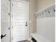 Clean and functional entryway with bench, coat hooks, and convenient storage at 18398 Cross Lakes Ct, Westfield, IN 46074