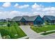 Attractive blue home with a spacious driveway and professionally landscaped front yard at 18398 Cross Lakes Ct, Westfield, IN 46074