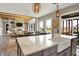 Open-concept kitchen with white marble countertops, stainless steel appliances, and backyard access at 18398 Cross Lakes Ct, Westfield, IN 46074