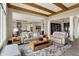 Spacious living room with wood beam ceiling, stylish furniture, and open layout to kitchen at 18398 Cross Lakes Ct, Westfield, IN 46074