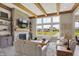 Cozy living room features a stone fireplace, wood beam ceiling, and pond view at 18398 Cross Lakes Ct, Westfield, IN 46074