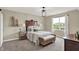 This cozy main bedroom features a large bed, dark wood furniture, and a window with natural light at 18398 Cross Lakes Ct, Westfield, IN 46074