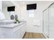 Modern bathroom features a granite vanity, a large mirror, and a glass shower, offering a refreshing spa-like experience at 18736 Moray St, Westfield, IN 46074