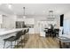 Bright open floor plan featuring a kitchen with a center island and adjacent dining area with modern lighting at 18736 Moray St, Westfield, IN 46074
