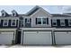 Charming two-story townhouse featuring gray siding, black shutters, and a spacious two-car garage at 18736 Moray St, Westfield, IN 46074
