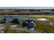 An aerial view of homes near a serene pond, framed by green fields and a distant highway at 201 St Andrews Ave, Edinburgh, IN 46124