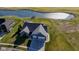 Aerial view of a well-manicured property featuring lush greenery, beautiful landscaping, and a tranquil pond at 201 St Andrews Ave, Edinburgh, IN 46124