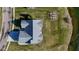 An aerial view of a well-maintained home, showcasing its gray roof, landscaping, and proximity to a pond at 201 St Andrews Ave, Edinburgh, IN 46124