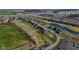 An aerial view of a neighborhood showcases well-maintained homes nestled along a golf course and small lakes at 201 St Andrews Ave, Edinburgh, IN 46124