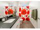 Bright bathroom featuring a vanity with a dark countertop and a shower with a vibrant floral curtain at 201 St Andrews Ave, Edinburgh, IN 46124