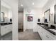 Elegant bathroom features dual sinks, black countertops, and a stylish shower, offering modern comfort at 201 St Andrews Ave, Edinburgh, IN 46124