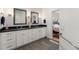 Tastefully designed bathroom boasts dual vanities, modern fixtures, and a door to the main bedroom at 201 St Andrews Ave, Edinburgh, IN 46124