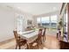 Well-lit dining room featuring a large window with a scenic view, a wooden dining set, and hardwood floors at 201 St Andrews Ave, Edinburgh, IN 46124
