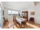 Bright dining room with large windows overlooking a serene outdoor view and a classic wooden dining set at 201 St Andrews Ave, Edinburgh, IN 46124