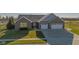 Beautifully landscaped brick home with a two-car garage and view of the golf course at 201 St Andrews Ave, Edinburgh, IN 46124