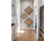 Hallway featuring hardwood floors and decorative wall art leading to other rooms at 201 St Andrews Ave, Edinburgh, IN 46124