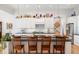 Open kitchen with barstool seating, stainless steel refrigerator, and decorative dishware at 201 St Andrews Ave, Edinburgh, IN 46124