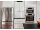 Gourmet kitchen featuring stainless steel appliances, including refrigerator and wall oven at 201 St Andrews Ave, Edinburgh, IN 46124