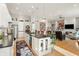 Bright, open kitchen with a large island, stainless appliances, white cabinetry and a view of the living room at 201 St Andrews Ave, Edinburgh, IN 46124