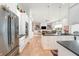 Open-concept kitchen with stainless steel appliances and island, flowing into the living space at 201 St Andrews Ave, Edinburgh, IN 46124