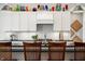 Modern kitchen featuring barstool seating, decorative dishware and unique lighting fixture at 201 St Andrews Ave, Edinburgh, IN 46124